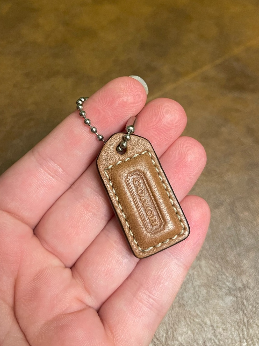 Brown coach hang tag
